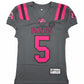 Gray sports jersey with pink and red text and logos on a carpeted floor