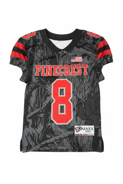 Black sports jersey with red and white text and numbers, featuring a brand label on a gray background.