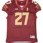 Maroon sports jersey with gold lettering on a gray surface
